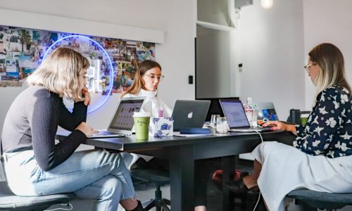 students working at desk with computers in study group